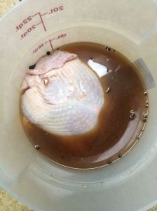 Turkey taking a brine-bath. The brine does not provide complete coverage, which is one reason for flipping the bird mid-way through.